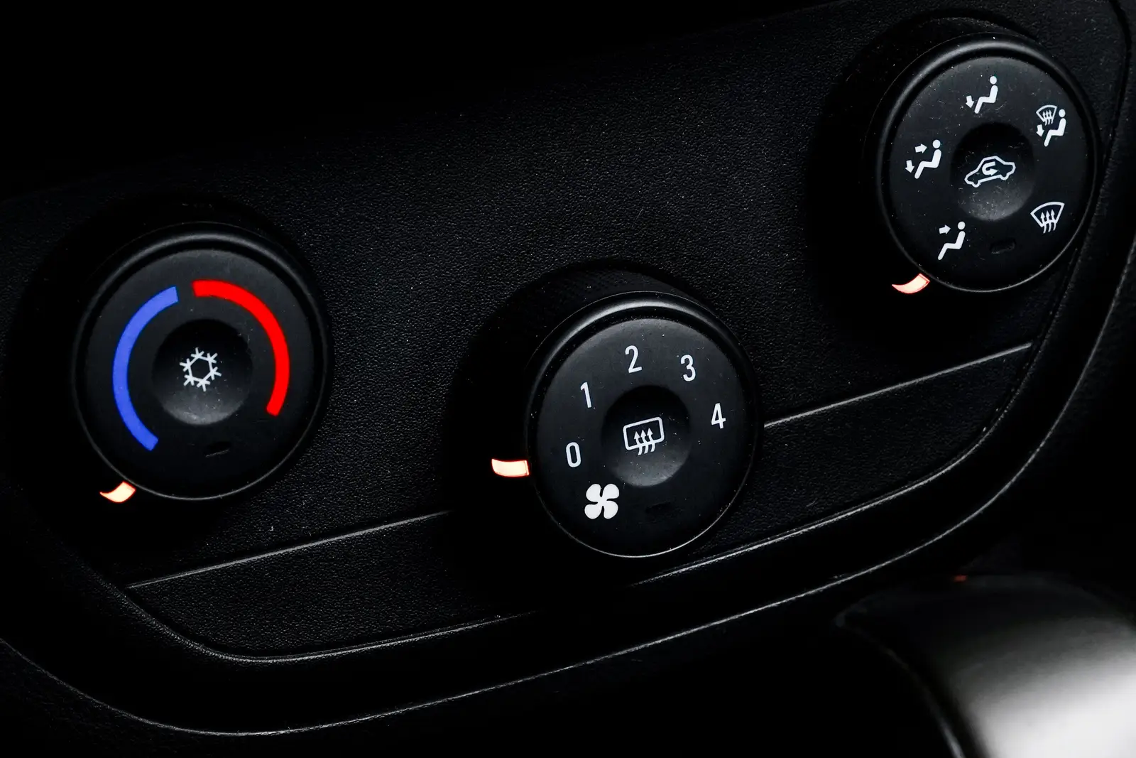 Car heater controls: a blue-to-red temperature dial, a fan speed dial and an air direction dial with a windshield defrost setting